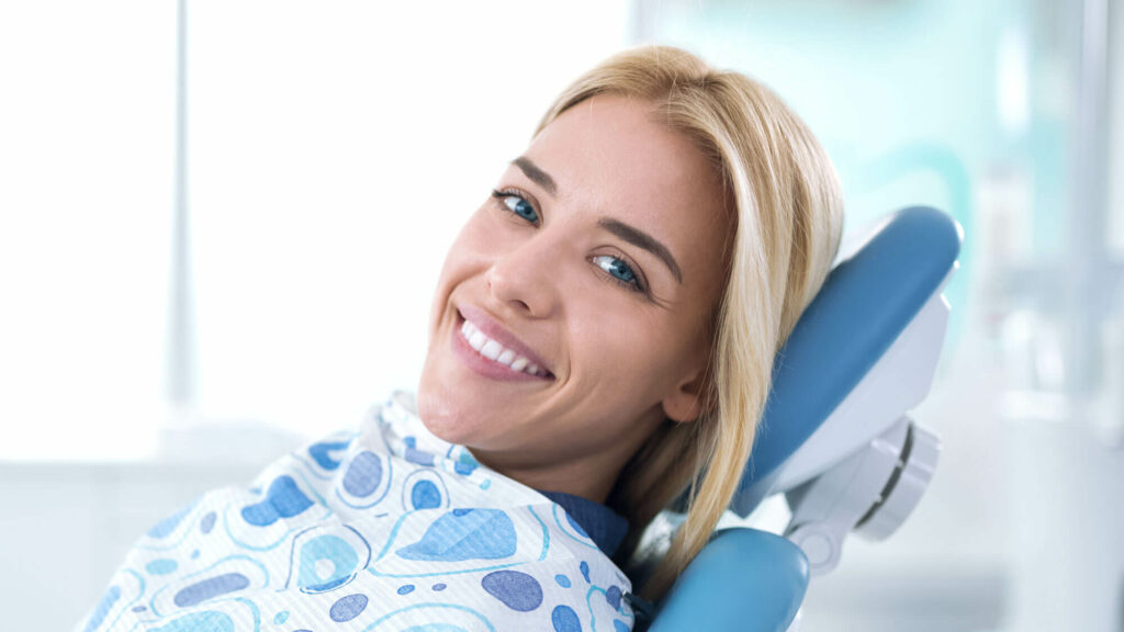 smiling woman in dental chair